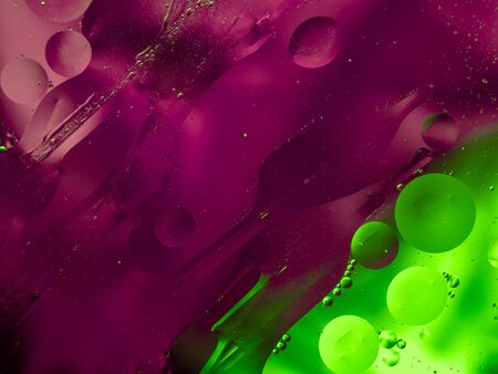 Colourful surreal psychedelic abstract liquid background. Water and oil drops with small air bubbles