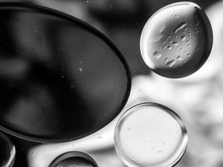 Monochrome surreal psychedelic abstract liquid background. Water and oil drops with small air bubblesの写真素材