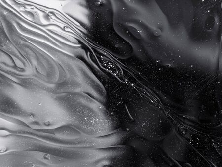 Monochrome surreal psychedelic abstract liquid background. Water and oil drops with small air bubblesの写真素材