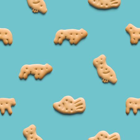 Rounded fresh crispy cookies on light blue background. Seamless texture. Top viewの写真素材