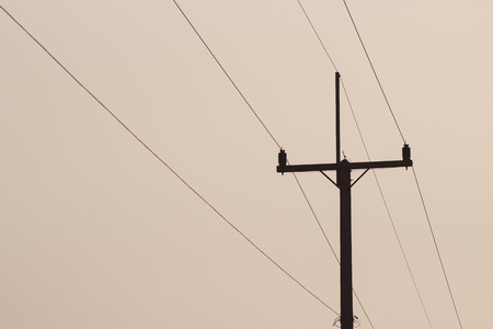 Concrete Electric Pole Standing in The Cloudy SKY, Silhouetteの写真素材