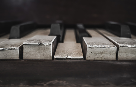 Closeup of Antique Piano Keys and Wood Grain with Drak Toneの写真素材