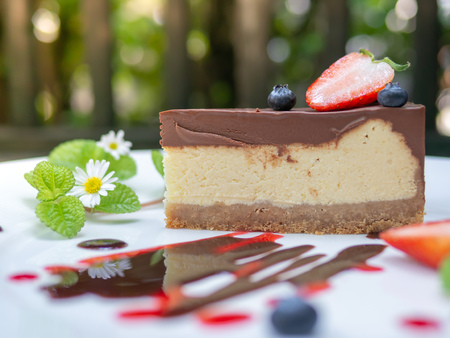 Choccolate Cheesecake with Strawberry and Blueberry on The Plate on The Wooden Backgroundの写真素材