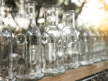 Clear Glass Bottle on The Wooden Shelves in Reflectionの写真素材