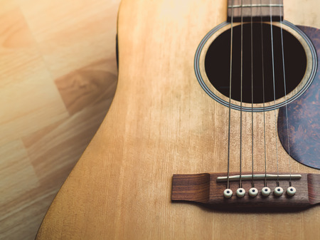 Acoustic Guitar on Wooden Background with Copy Space