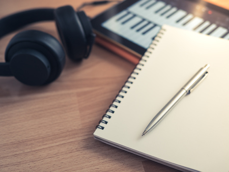 Music Creation Tools, Headphone, Notebook, Electronic Tablet and Pen on Wooden Backgroundの写真素材