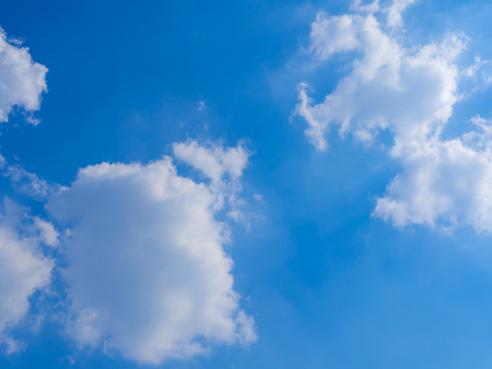 Blue Sky Background with White Clouds in Sunshine Dayの写真素材