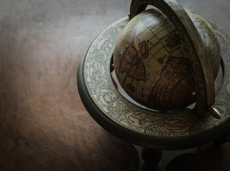 The Old Wooden Classic World Globe with Cement Backgroud in Mystery Conceptの写真素材
