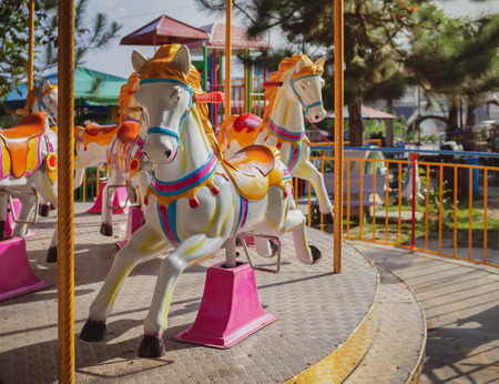 Traditional Carousel Horse on a Carnival Merry Go Roundon Fun Fair in The Park on Vintage Styleのeditorial素材