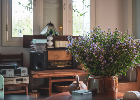 Living Room Decoration with Wildflower, Ceramic Kettle, Old Lamp, Retro Radio Audio, Old Viedo Player, Music CD and Wooden Window in Traditional Vintage Styleの写真素材