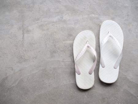 White Rubber Sandals Flip Flops on Cement Background Top Viewの写真素材