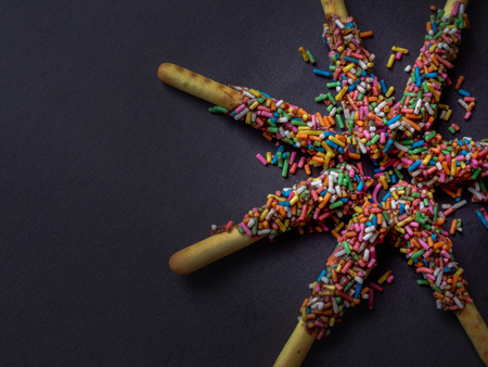 Bread Sticks with Chocolate and Colorful Topping with Space on Black Background for Fun Party Concept, Top Viewの写真素材