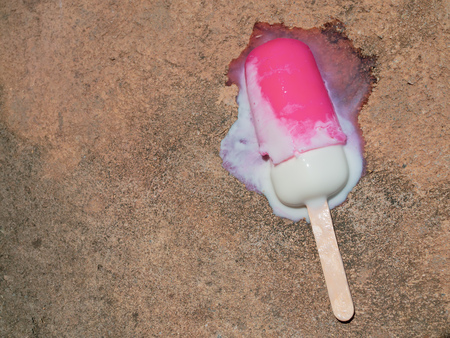 Pink  Ice Pop Fall on The Cement Floor and Melting from Hot Summerの写真素材