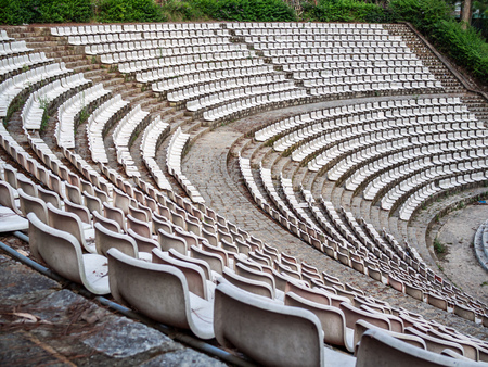 Old Empty White Seats of Rows in Old Outdoor Theaterの写真素材