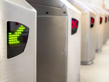 Green Arrow and Red Cross Sign on Electronic Ticket Gate in Railway Stationの写真素材