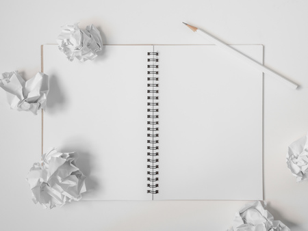Flat Lay of Blank  Notebook, White Pencil and Crumpled Ball Paper on White Background. Top View Get Idea Conceptの写真素材