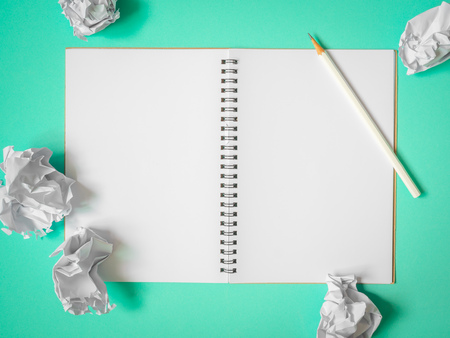 Flat Lay of Blank  Notebook, White Pencil and Crumpled Ball Paper on Aqua Green Blue Background. Top View Get Idea Conceptの写真素材
