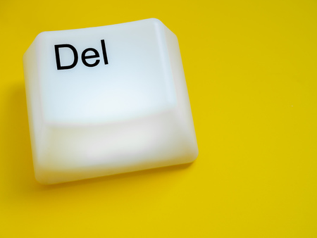 Big Delete Computer Key Button Light Box Isolated on Yellow Background with Space. Eraser Concept.の写真素材