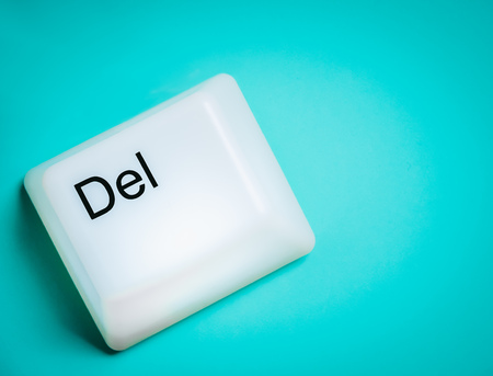 Flat Lay of Big Delete Computer Key Button Light Box Isolated on Aqua Blue or Green Background with Space. Eraser Concept.の写真素材