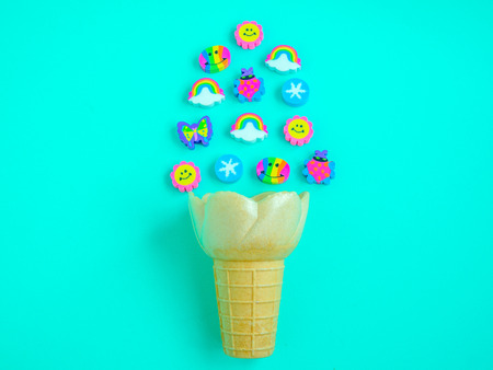 Ice Cream Cone with Cute Colorful Eraser Rubber on Aqua Blue Background, Minimal Summer Concept.の写真素材