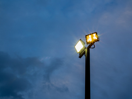 Spotlight Standing Tall on Dark Blue Sky Backgroundの写真素材