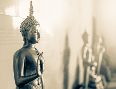 Black and White Golden Buddha Statue with Teaching Hand Mean Stop Doing Bad Thing with The Warm Light of Faith.の写真素材