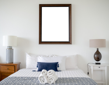Modern Bedroom with Blank Wooden Vintage Frame on The White Wall Interior Backgroundの写真素材