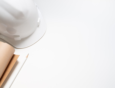 flat lay white hard Safety helmet with paper and pencil for engineering worker isolated on white background top view with space.の写真素材
