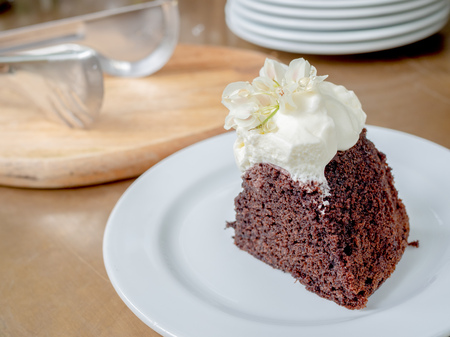 A piece of wild organic chocolate honey cake with beautiful vintage flowers topping and whipping...