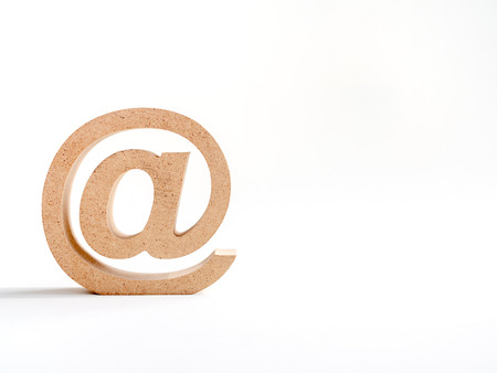 Wooden E-mail address symbol, arroba icon isolated on white background with copy space. E-mail marketing online internet concept.の写真素材