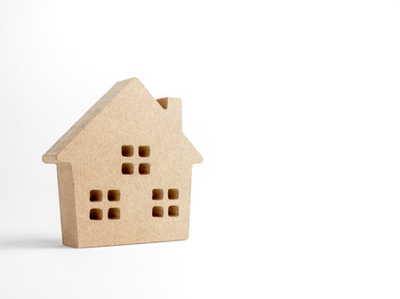 Wooden house isolated on white background with copy space. Property investment and family concept.の写真素材