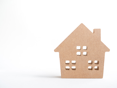 Wooden house isolated on white background with copy space. Property investment and family concept.の写真素材