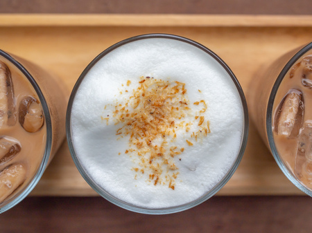 Close-up flat lay of  glasses of iced coffee on wooden table background top view.の写真素材