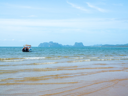 Motor boat floating on the sea. Travel speed boat on the sea near the seashore on blue sky background.の写真素材