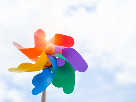 Beautiful colorful pinwheel on blue sky background on sunny day with copy space.の写真素材
