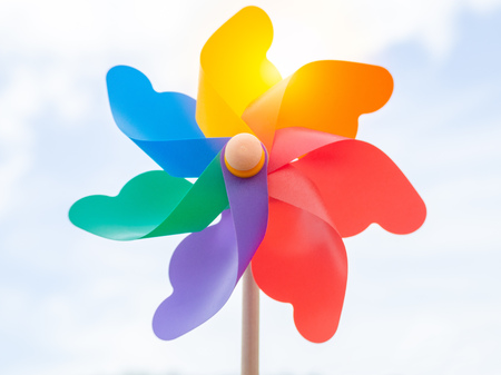 Beautiful colorful pinwheel on blue sky background on sunny day.の写真素材