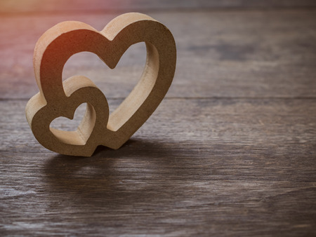 Wooden twin hearts on old wooden texture background with copy space. Love concept.の写真素材