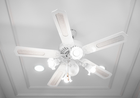 Vintage classic white ceiling fan with the light  on white background.の写真素材