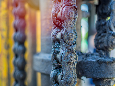 Close-up dirty and greasy chain of old forklifts with engine oil and lifting hydraulic cylinder.