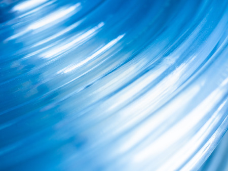 Transparent plastic water hose. Abstarct blue curve line background.の写真素材