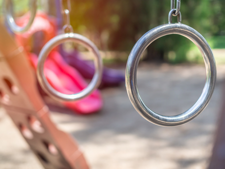 Closeup metal gymnastic rings in playground.