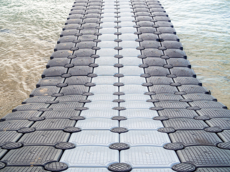 KRABI, THAILAND - November 2, 2018 : Black and white plastic pontoon walk way floating in the sea. Plastic Floating Dock. Plastic Pontoon bridge.のeditorial素材