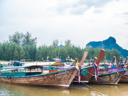 KRABI, THAILAND - NOVEMBER 3, 2018 - Many traditional travel long-tail boats parking Ao Nang port with seascape background at Krabi, Thailand.のeditorial素材