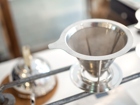 Stainless steel coffee filter reusable funnel coffee dripper, V-type filter cup with copy space.