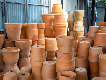 Many piles of terracotta pots in local terracotta pot factory.の写真素材