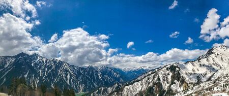Beautiful snow mountain view with blue sky and cloud on Tateyama Kurobe alpine route, Japanese alps...
