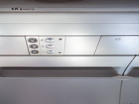 Control panel overhead and icons in economy class cabin
in airplane for adjust air conditioning and lights with copy space.の写真素材
