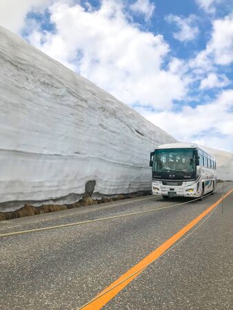 TATEYAMA, JAPAN - May 17, 2019 : Snow corridor in Tateyama. Travel bus on the road between snow wall, a part of Kurobe Alpine route which offers spectacular views around Tateyama mountain.のeditorial素材