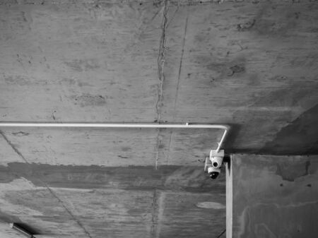 CCTV camera installed on concrete ceiling in the parking lot in condominium with copy space.の写真素材