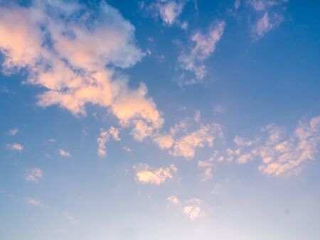 Beautiful golden clouds on sunset sky background. Blue sky background with golden light from sunlight shining on the clouds.の写真素材